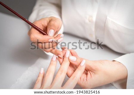 Similar – Frau in einem Nagelsalon, die eine Maniküre mit Nagelfeile erhält.