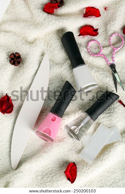 French manicure set with strengthener,white
tip polish, dividers and top coat shine applicator for nails on
towel background