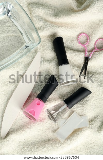 French manicure set with strengthener,white\
tip polish, dividers and top coat shine applicator for nails on\
towel background