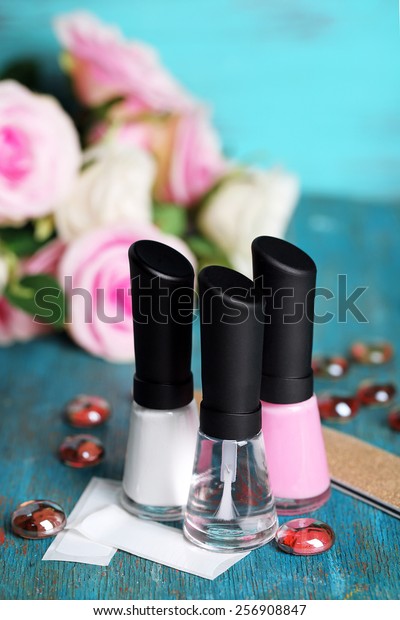 French\
manicure set with white tip polish, dividers and top coat shine\
applicator for nails on color wooden\
background