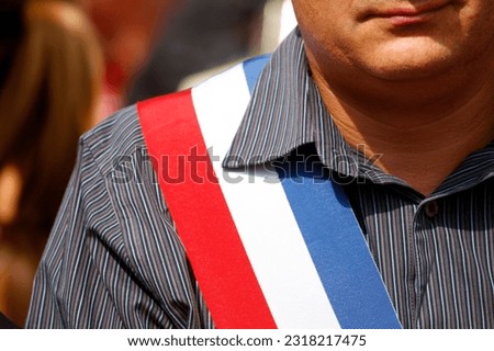 French mayor with tricolour scarf.