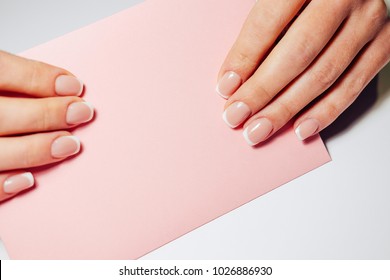 French nail extensions. Women with beautiful manicure and wedding ring holding a pink envelope with weding invitation. - Powered by Shutterstock