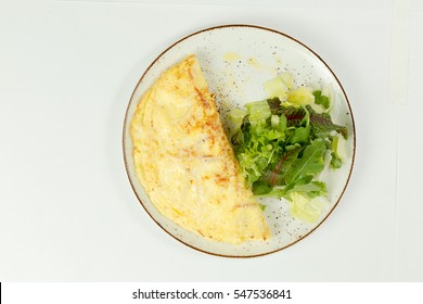 French Omelette With Salad On White Background