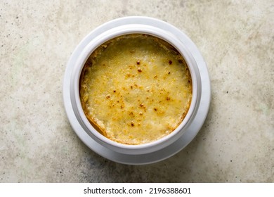 French Onion Soup With Cheese On Bowl Top View On Stone Table