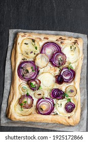 French  Onion Tart On Black Stone Background 