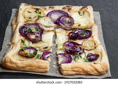 French  Onion Tart On Black Stone Background 