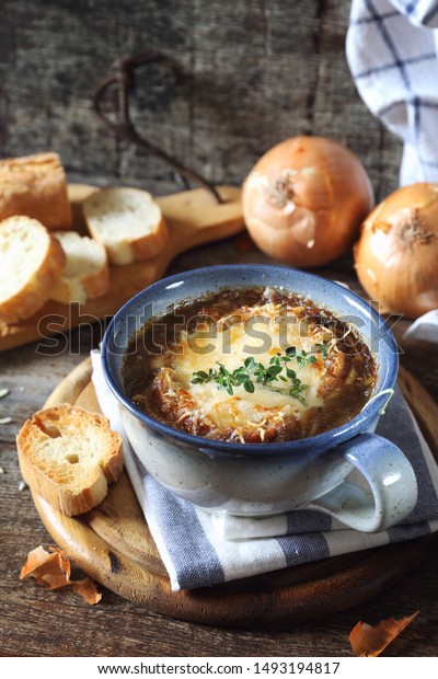 French onions soup with baguette, rustic style\
on wooden background
