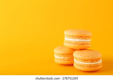 French Orange Macarons On Orange Background