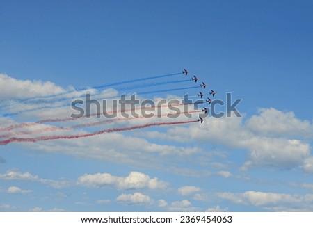 The French Patrol (patrouille francaise) flying in formation and releasing colored smoke during a display
