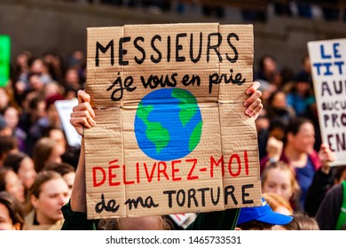 French Placard Held By Environmentalist. A Close Up View Of A French Sign, Saying Gentlemen, Please Release Me From My Torture, Held By A Climate Change Campaigner During A City Protest.