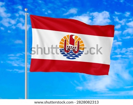 French Polynesia flag waving in the wind against a bright blue sky with white clouds.
