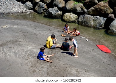 French Polynesia, Marquesas, Hiva Oa Island. 16th Of October 2017. Scenery Of Polynesian Kids Playing Near The Water.