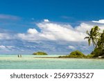 French Polynesia, Rangiroa Atoll. Men wading in Blue Lagoon.