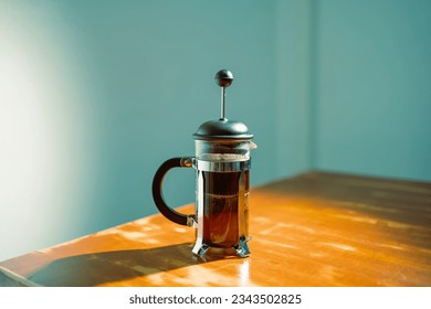 French press coffee maker on a table - Powered by Shutterstock