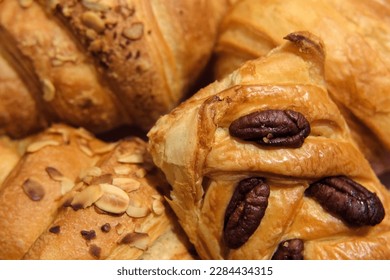 French puff pastry and croissant with toppings. Freshly baked sweet buns couple flaky pastry with almond nuts in a white plate for dessert. Delicious Breakfast or brunch concept. Burekas, turnovers. - Powered by Shutterstock