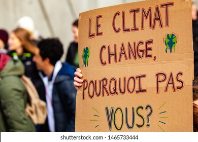 French sign at environmental protest. A French poster is viewed close-up, saying the climate is changing, why not you, as during an ecological activism march on a street in Montreal, Canada