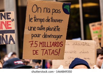 French Sign Held At Ecological Rally. A Closeup View Of A French Sign Saying There Is No Time To Find Another Planet To Relocate 7.5 Billion People. Demonstrators March For The Environment.