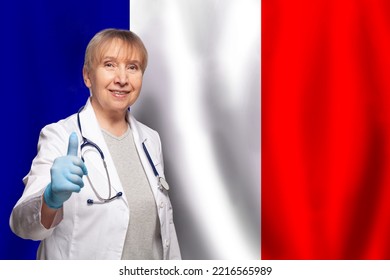 French Smiling Mature Doctor Woman Holding Stethoscope On Flag Of France Background