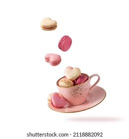 French sweet colorful cookies macarons macaroons in vintage pink cup flying isolated on white background.  Heart shape macarons falling into cup. Pastry shop love card with copy space - Powered by Shutterstock