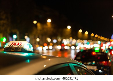 French Taxi With The Champs Elysees Avenue In Background