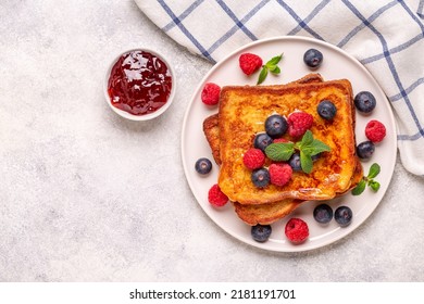 French toast with blueberries, raspberries, maple syrup, top view. - Powered by Shutterstock