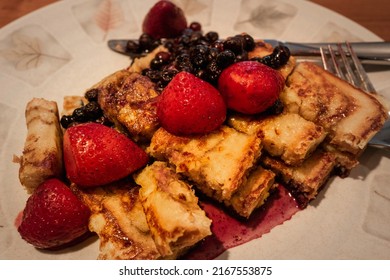 French Toast Breakfast With Strawberry, Blue Berry, And Maple Syrup Served In The Plate