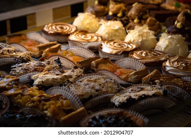 French traditional pastries from local organic ingredients on display in healthy lifestyle oriented patisserie. France. Sweet retro background. Difficult choice, indulgence concept. Low key photo