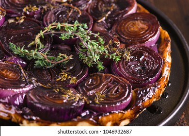 French Traditional Rustic Onion Tarte Tatin With Balsamic Vinegar, Caramel And Provence Herbs