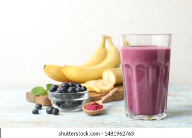 Fresh Acai Drink With Berries And Bananas On Wooden Table Against Light Background