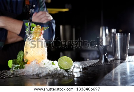 Fresh alcoholic Malibu and pineapple juice cocktail on bar counter. Space for text