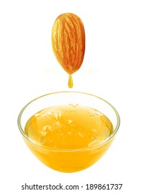 Fresh almond oil flowing from almond into the glass