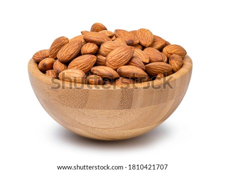 Fresh almonds nut in wooden bowl isolated on white background  with clipping path.