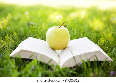 Fresh apple and open book - Powered by Shutterstock