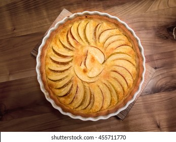 Fresh apple tarte on wooden table from above