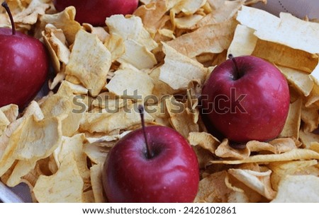 Fresh Apples In Box Filled With Dried Apple Slices. Domestic Apple Chips Cooking Concept Photo
