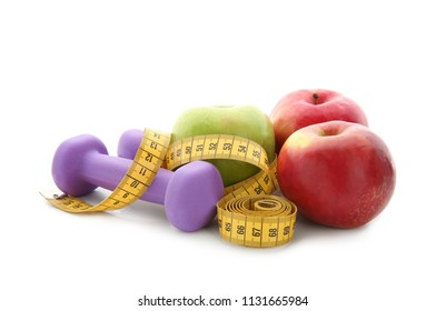 Fresh Apples, Dumbbells And Measuring Tape On White Background. Diet Food