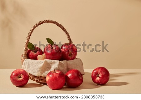 Fresh apples are placed inside a bamboo basket against pastel background. Product extracted from Apple (Malus domestica) reduces the appearance of dark circles
