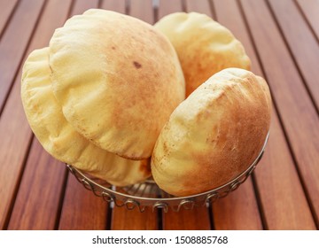 Fresh arabic bread on a wooden table
