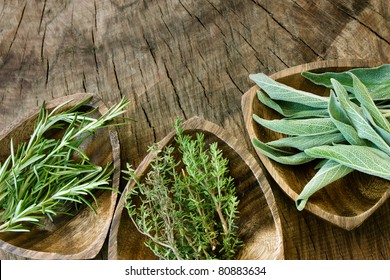 Fresh aromatic herbs on old wooden background