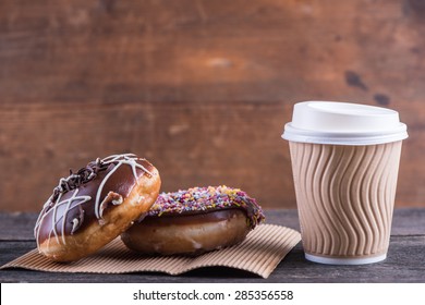 Fresh Artisan Donuts And Take Away Coffee, Wooden Background With Copy Space