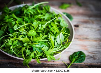 Fresh Arugula And Spinach Salad On Rustic Background