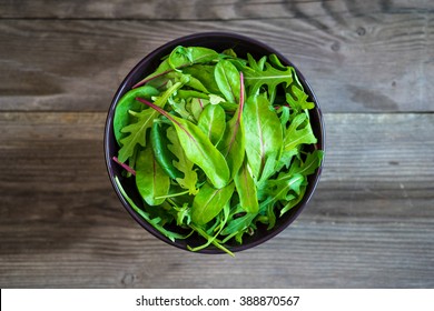 Fresh Arugula And Spinach Salad On Rustic Background