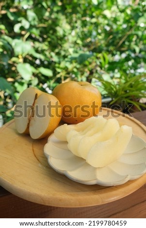 Fresh asian Snow pear fruit wooden background table. Fresh Nashi pears Taiwan pear Japanese Korean pear fruit delicious and sweet Premium  sunlight  on natural farm Cut and eat green natural Blur 