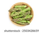 fresh asparagus in wooden bowl isolated on white background. Top view. Flat lay.