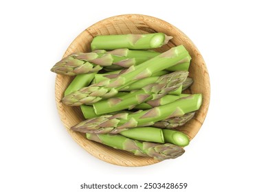 fresh asparagus in wooden bowl isolated on white background. Top view. Flat lay.