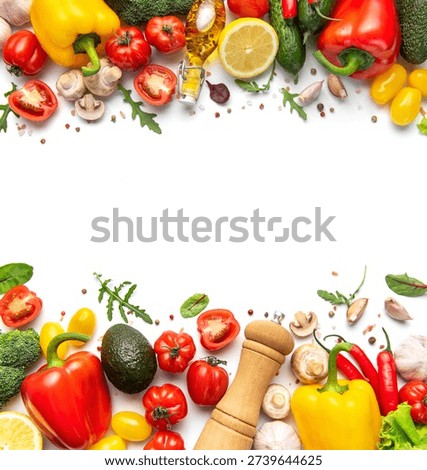 Fresh assorted vegetables and spices creating a colorful border on a white background