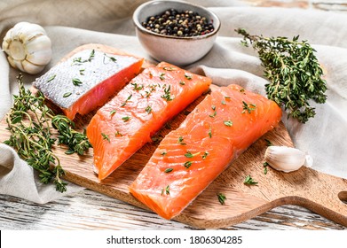 Fresh Atlantic Salmon Fillet On A Chopping Board. White Wooden Background. Top View