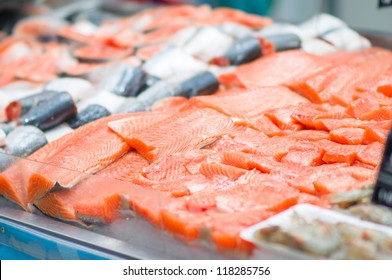 Fresh atlantic salmon lie on table with ice in supermarket