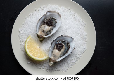 Fresh Australian Oysters On Plate Served With Lemon