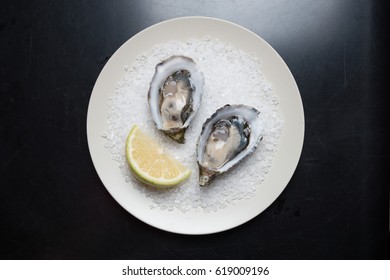 Fresh Australian Oysters On Plate Served With Lemon